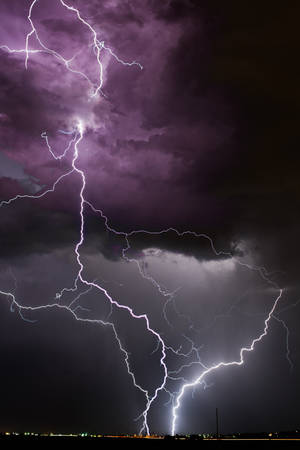 Witness An Epic Purple And Black Lightning Strike Wallpaper