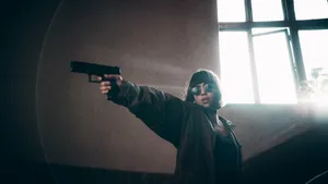 Woman Aiming Gun At Her Right Side Wallpaper