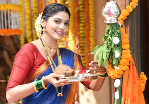 Woman Beside A Gudi Padwa Showpiece Wallpaper