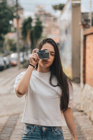 Woman Holding Black And Gray Bridge Camera Wallpaper