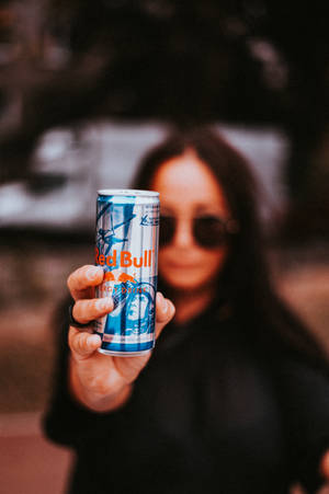 Woman Holding Red Bull Beverage Tin Can Wallpaper