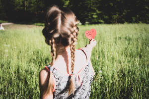 Woman In White And Black Floral Tank Top Holding Heart Balloon Wallpaper