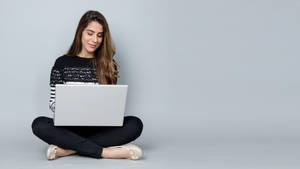 Woman Reading On Laptop Wallpaper