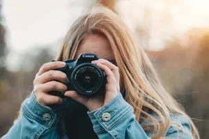 Woman Taking Photo During Daytime Wallpaper
