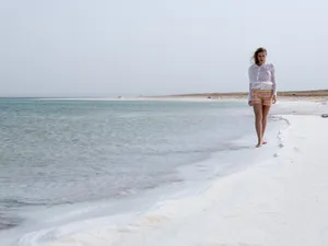 Woman Walking On Dead Sea Shore Wallpaper