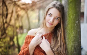 Woman Wearing An Orange Off Shoulder Knit Sweater Wallpaper