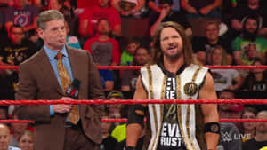 Wwe Commentator Vince Mcmahon Discussing With Aj Styles Wallpaper