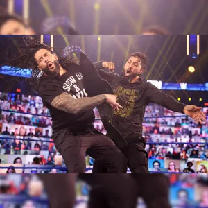 Wwe's Jey Uso In Action Against Roman Reigns Wallpaper