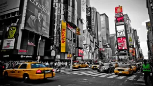 Yellow Taxi Cab In City Greyscale Wallpaper