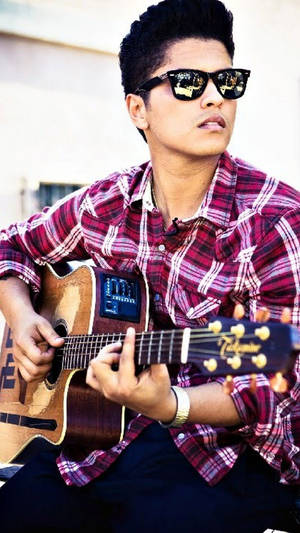 Young Bruno Mars Strumming A Guitar Wallpaper