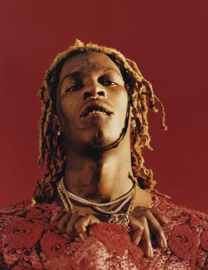 Young Thug Posing By A Red Phone Wallpaper
