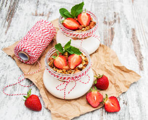 Yummy Yogurt With Granola And Strawberries Wallpaper