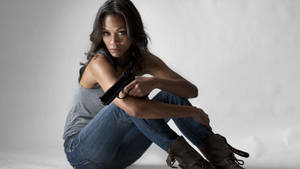 Zoe Saldana Posing Elegantly On A Canvas Wallpaper