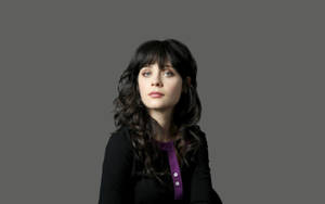 Zooey Deschanel In Black On Gray Background Wallpaper